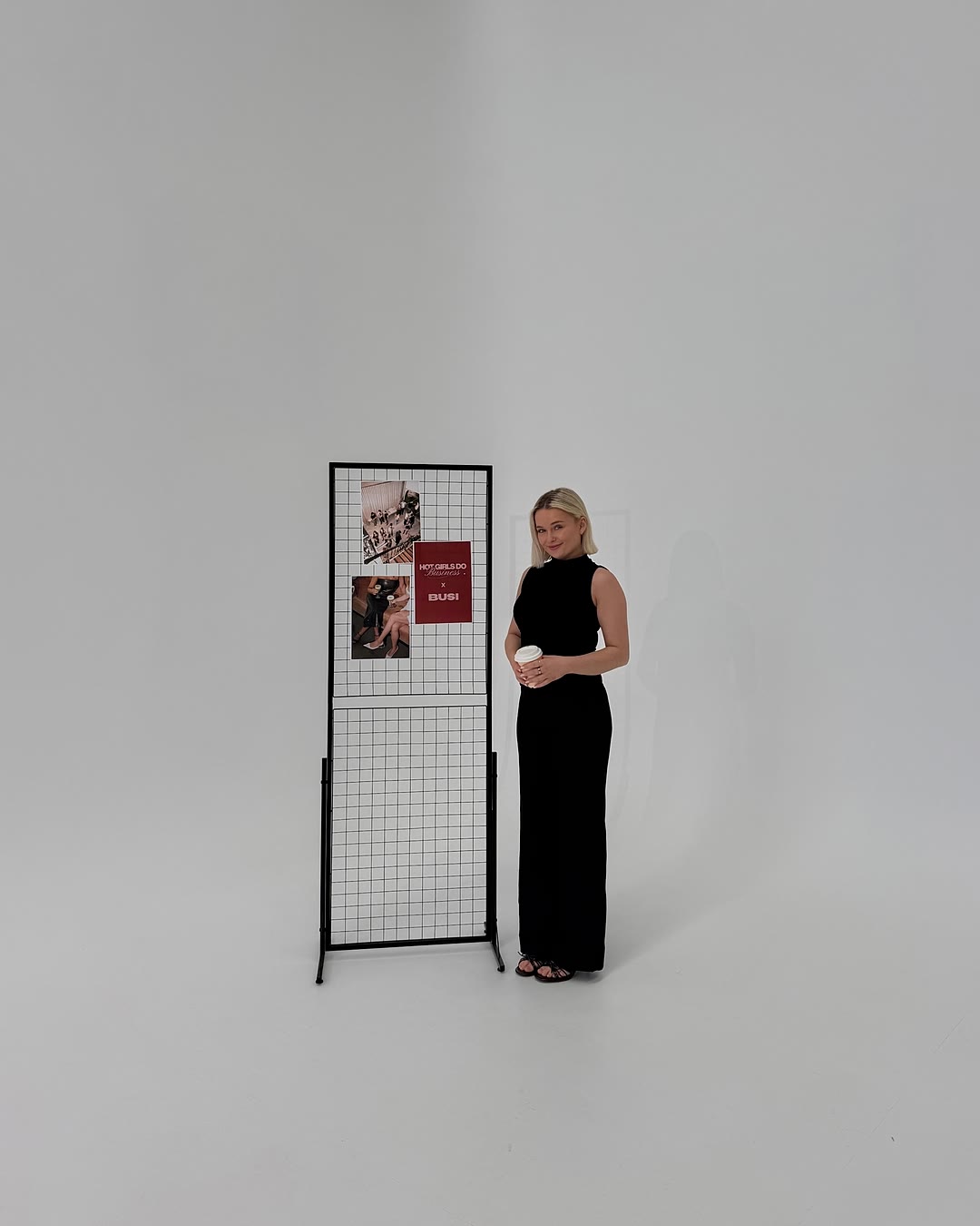 Zoe standing beside the display board in a bright studio